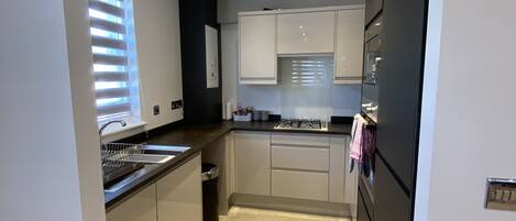 Microwave, dishwasher, coffee/tea maker, cookware/dishes/utensils