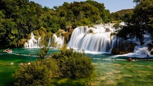 A waterfall cascading into a turquoise pool surrounded by lush greenery. - Room in Vodice with Terrace, Air condition, WIFI (4826-2) (Vodice)