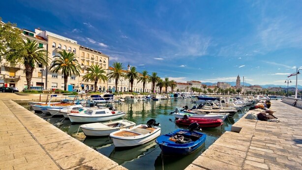 A marina with boats docked along a waterfront promenade, lined with palm trees and historic buildings. - Holiday Home in Split with Seaview, Terrace, Air condition, WIFI (4937-1) (Split)