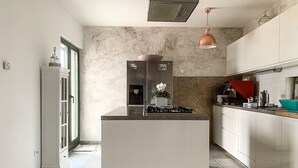 A modern kitchen with a central island, white cabinetry, and a stainless steel refrigerator. - Holiday Home in Split with Seaview, Terrace, Air condition, WIFI (4937-1) (Split)
