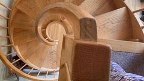 A wooden spiral staircase with a central column and wooden handrails. - Clean, quiet and cozy mountain get away Condo (Bartlett,)