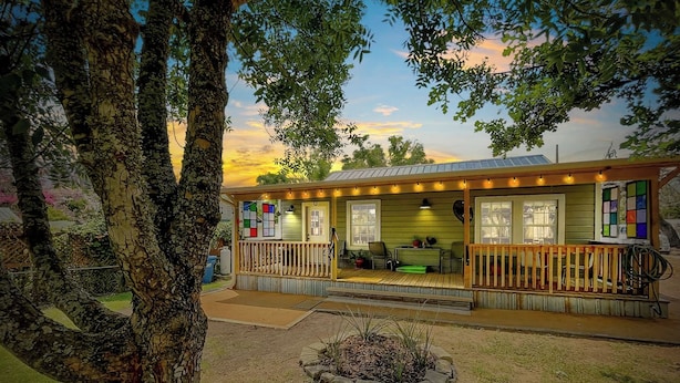 A two-story building with a porch and a covered outdoor seating area. - Cherry Street | Near Main | Gas BBQ | Couples (Bandera)