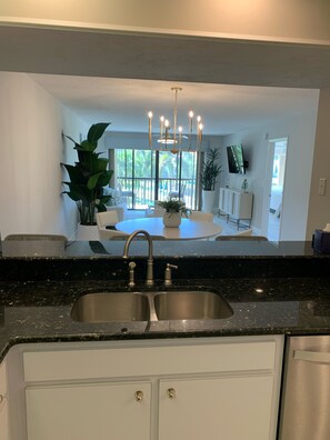 Enjoy cooking in this spacious kitchen with a central island, double sink, and chandelier.
