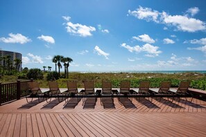 Relax on the elevated deck with lounge chairs overlooking the beach and ocean.