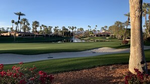 A golf course with sand bunkers, palm trees, and a pond. - Endless views in Indian Wells!  Desert Horizons new and improved in 2024! (Indian Wells)