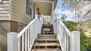 A wooden staircase with white railings leading to a covered porch. - Pet-Friendly Lakehouse: View Tower + Fire Pit! (Leesville)