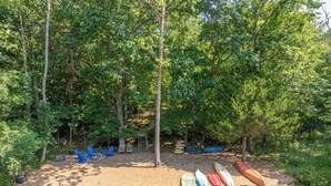 A lakeside campsite with kayaks and a fire pit. - Peace of Lake Aspen Pt. II by Innsbrook Vacations! (Innsbrook)