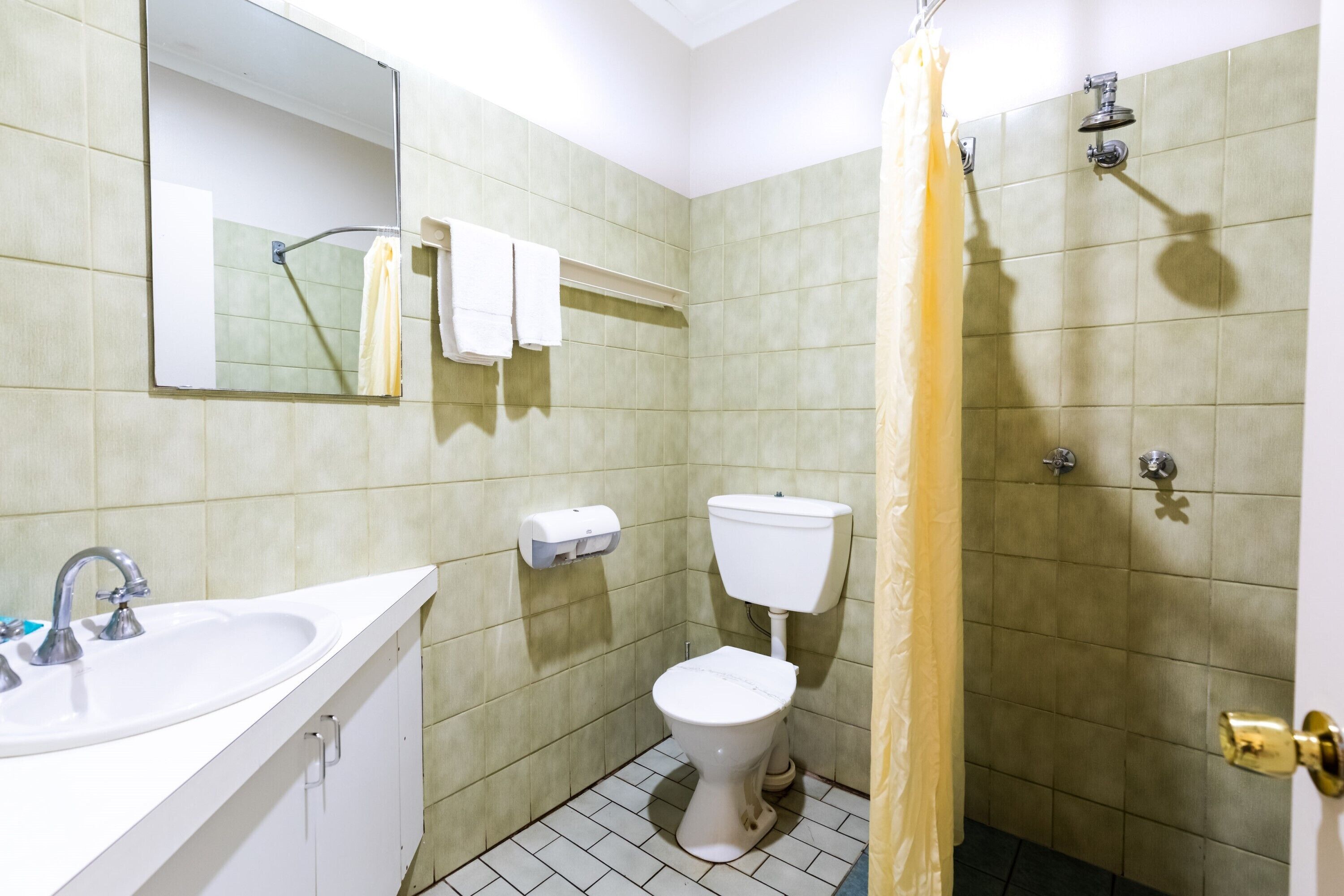 A bathroom with a sink, toilet, and shower.