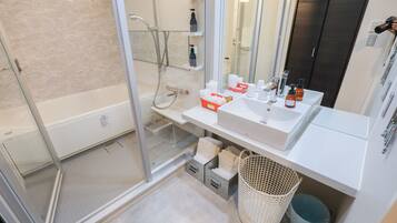 Separate bathtub and shower, free toiletries, hair dryer, slippers
