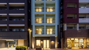 A multi-story hotel with balconies, a ground-level entrance, and a street view. - HOTEL SO SUMIYOSHI (Fukuoka)