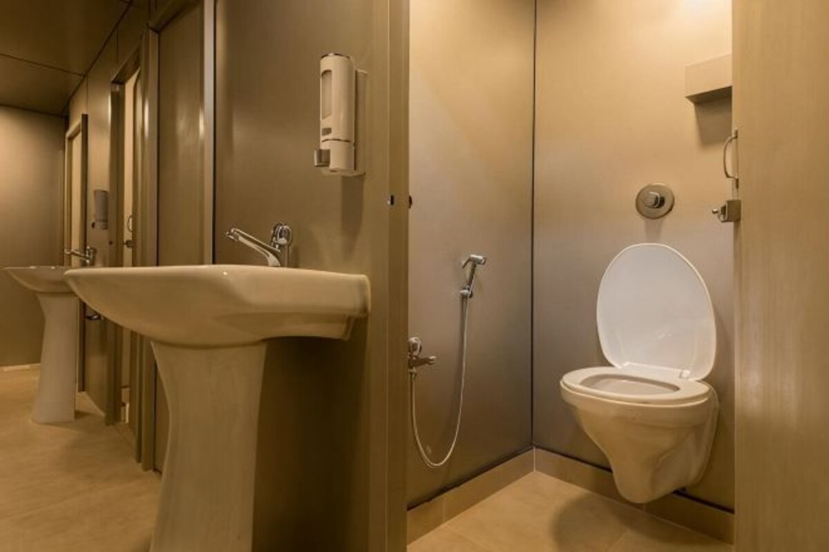 A bathroom with a sink, toilet, and shower.