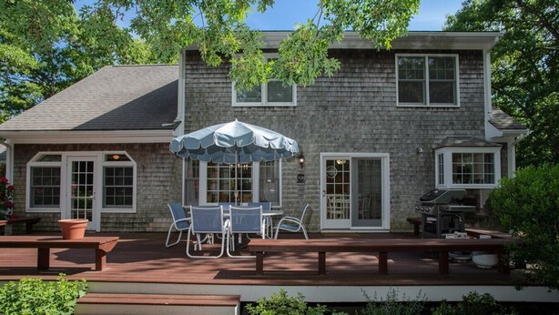 A two-story house with a patio, outdoor seating, and a grill. - Family Fun, Spacious+Game Room (Oak Bluffs)