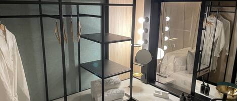 A modern bathroom with a vanity, mirror, and shelves.
