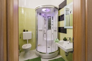 A bathroom with a glass-enclosed shower, a toilet, and a sink with a mirror. - A2 - Modern Luxury apt w. big Balcony, sea View, (Kastela)