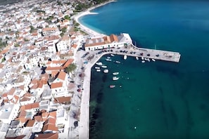 An aerial view of a coastal town with a marina, white buildings with red roofs, and a clear blue sea. - A2 - Modern Luxury apt w. big Balcony, sea View, (Kastela)