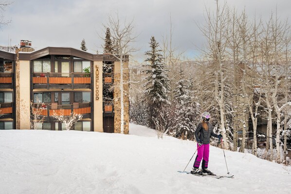 A ski resort building with a ski slope in the foreground.