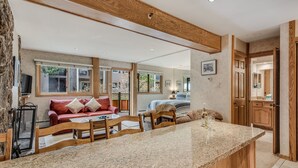 A modern kitchen with a granite countertop, wooden cabinets, and a built-in island. - 🏔️Slopeside~Hot Tub~Studio Deluxe 407🏔️ (Snowmass Village)