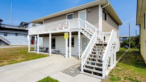 A two-story house with a covered porch and a staircase leading to the upper floor. - Fun, Chill, and Coastal Comfort at Hoot (Topsail Beach)