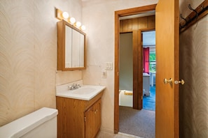 A bathroom with a vanity, sink, mirror, and lights. - 2 bedroom Killington condo with fireplace, kitchen, and Wi-Fi. (Killington)