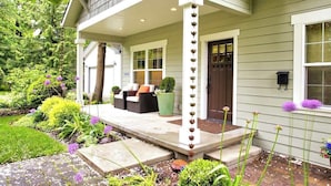 A house with a covered porch, a door, and a window.