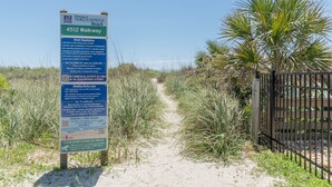 A beach access sign with regulations and a pathway leading to the beach. - Immaculate two bedroom, two bath oceanview condo located in the heart of North Myrtle Beach!! (North Myrtle Beach)