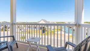 A covered outdoor area with a table and chairs, overlooking a beach and a pool. - Immaculate two bedroom, two bath oceanview condo located in the heart of North Myrtle Beach!! (North Myrtle Beach)