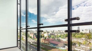 A view from a high-rise window overlooking a cityscape with buildings, roads, and greenery. - Modern Studio | Parking | Air Conditioning | Close to Expo XXI (Warszawa)