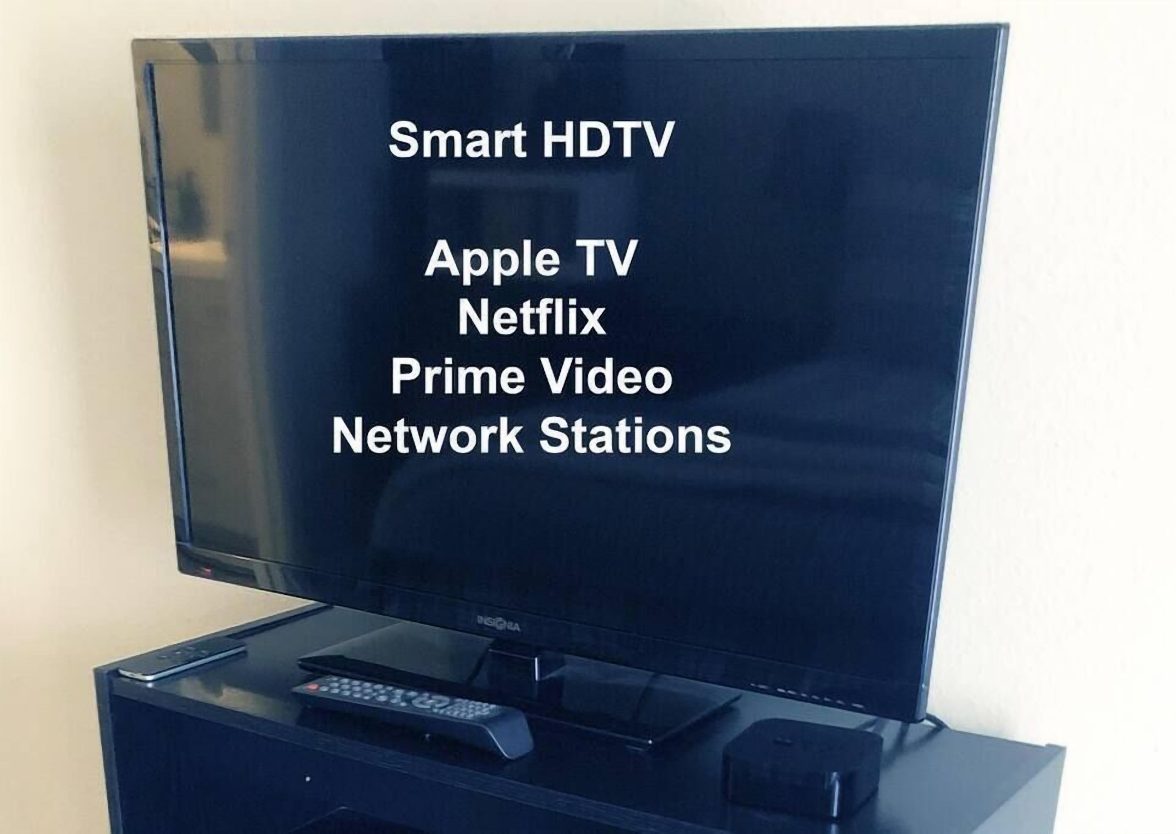 A flat-screen TV with a stand.