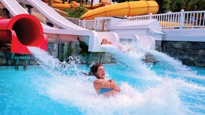 A water park with a large pool and water slides.