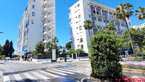 A modern building with balconies and a sign that reads "SKOL". - Skol 521 - Fantastic Beachfront Studio Holiday Home (Marbella)