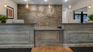 A reception area with a stone wall and a 'Birmingham Falls' sign. - Best Western Plus Rumford Falls (Rumford)