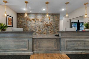 A reception area with a stone wall and a 'Birmingham Falls' sign.