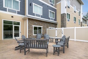 A patio area with outdoor furniture and a fire pit. - Best Western Plus Rumford Falls (Rumford)