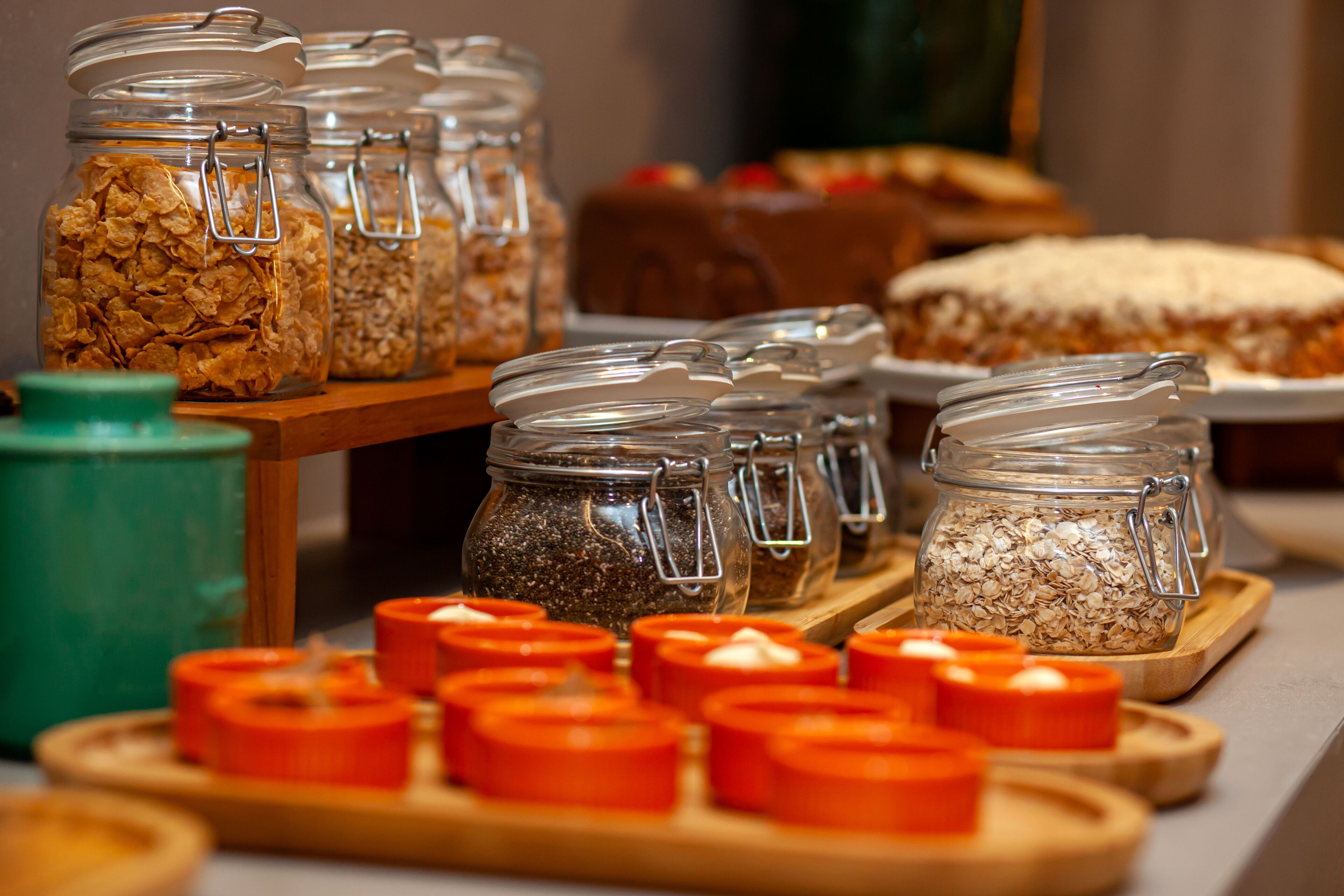 A buffet with various food items and a cake on a table.