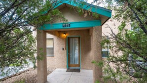 A building with a teal-colored roof and a door marked with the number 517. - The Blue House (Truth or Consequences)