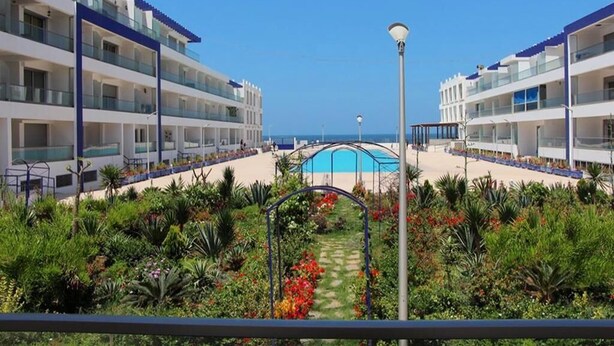 A hotel with multiple balconies, a swimming pool, and a garden area. - Residence Adan Beach 4790 (Aourir)