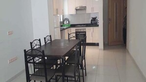A compact kitchen with a dining area.