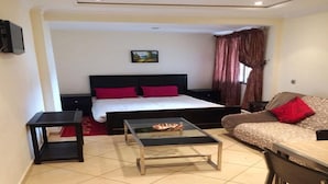 A compact hotel room with a bed, a small table, a sofa, and a TV mounted on the wall. - Residence Apart Hotel Founty Beach 5121 (Agadir)