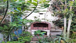 A brick-built outdoor oven structure surrounded by dense foliage. - Large Beachfront Villa in Sonaba Agadir 5164 (Agadir)