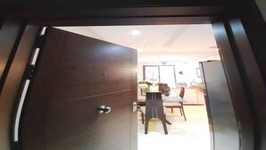 A hotel room entrance with a wooden door and a number '004' above it. - Residence Hivernage Founty 5165 (Agadir)