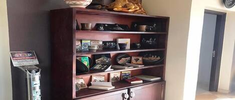 A wooden bookshelf with decorative items and books.
