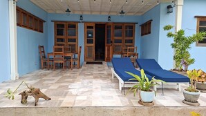 A covered outdoor area with a checkered floor, wooden furniture, and potted plants. - VillaMerissa Nestled between two unspoiled beaches Pool/JackSprat/WiFi/Gym/Staff (Treasure Beach)