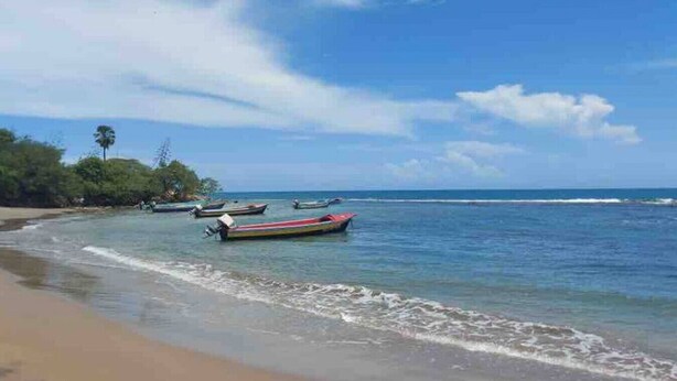 A beach with boats and calm water. - VillaMerissa Nestled between two unspoiled beaches Pool/JackSprat/WiFi/Gym/Staff (Treasure Beach)