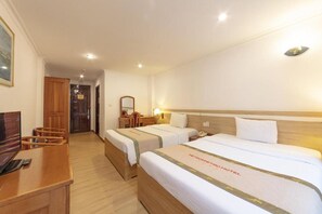 A hotel room with two beds, a desk, and a chair. - Vietsovpetro Dalat Hotel (Xuan Huong - Da Lat)