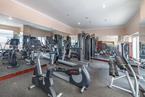 A gym with cardio machines, free weights, and mirrors. - Vietsovpetro Dalat Hotel (Xuan Huong - Da Lat)