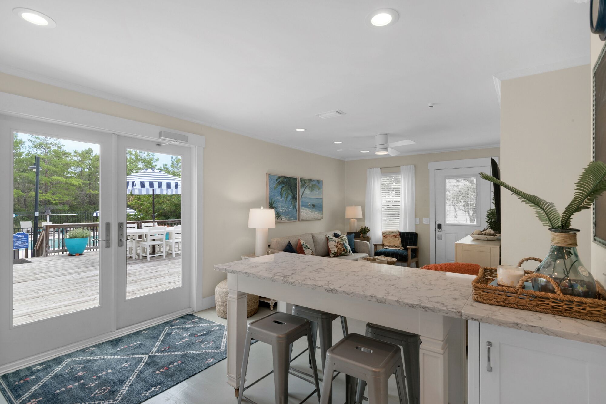 A spacious kitchen with a large island, a dining area with a view, and a patio with outdoor seating.