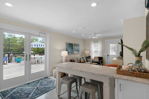 A spacious kitchen with a large island, a dining area with a view, and a patio with outdoor seating.
