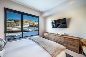 Enjoy a serene view of the river and surrounding landscape from the comfort of this cozy room.