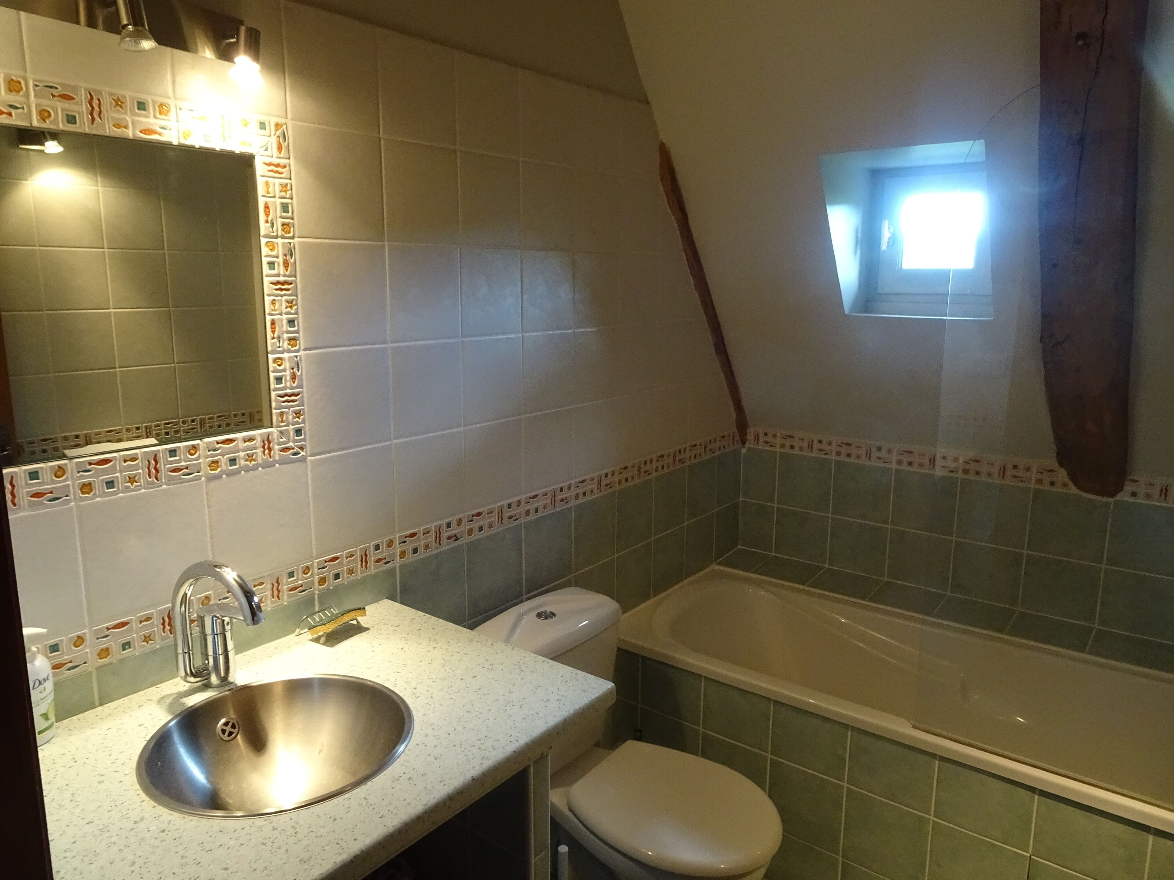 A bathroom with a sink, toilet, and bathtub.