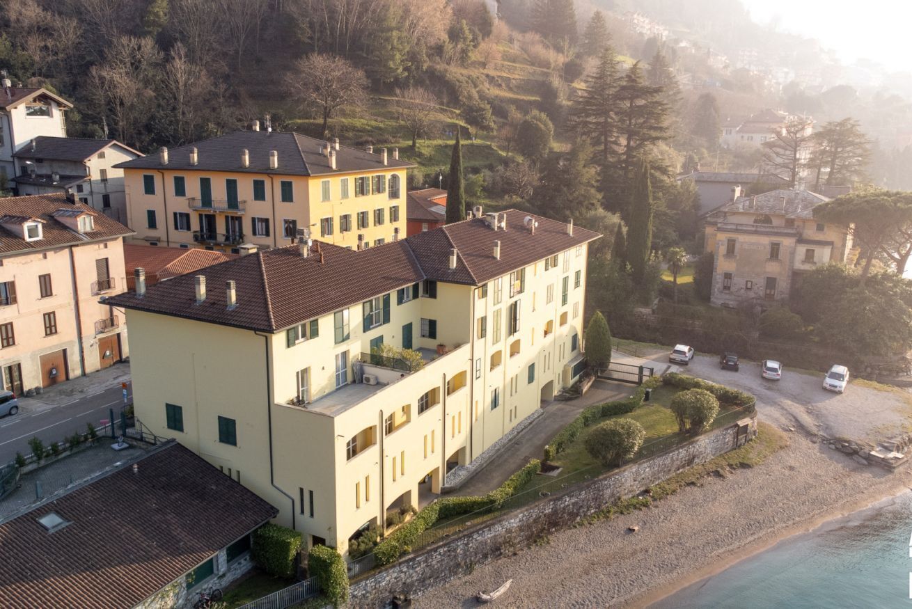 A coastal building complex with multiple balconies and a beachside location.